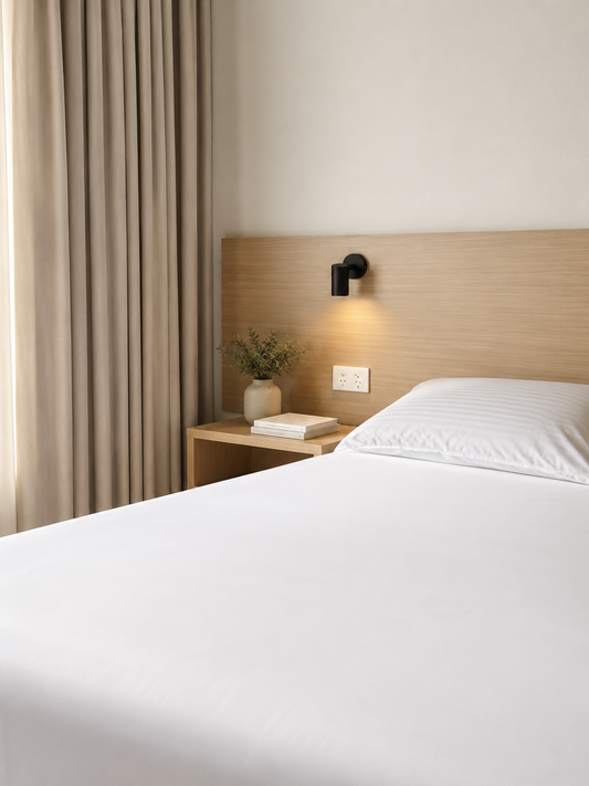 Peace of Mind fitted sheet styled on a bed with neutral linen and cushions